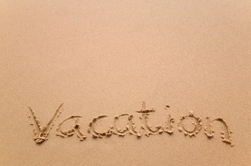 Vacation written in sand