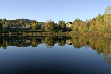 Fototapeta premium autumn reflections on a lake in the morning