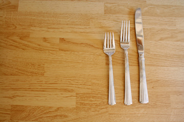 Two forks and a knife