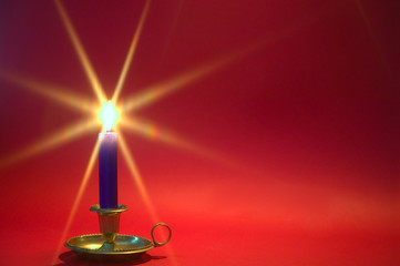 Blue candle on red background.