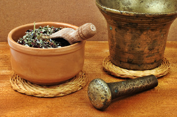 Mortar and pestle with bowl  with herbs