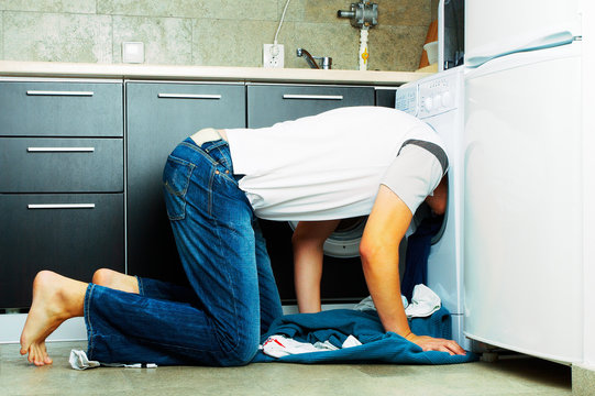 Man Looking Inside The Washing Machine