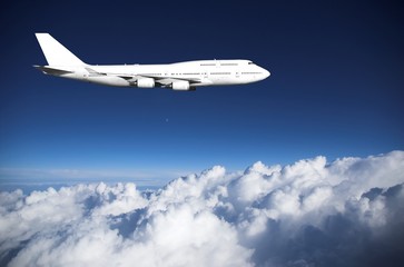Jumbo jet  above clouds - obrazy, fototapety, plakaty