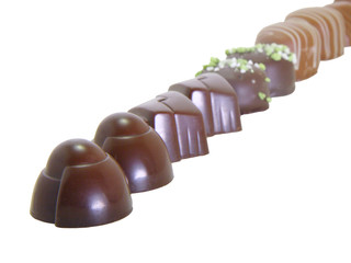 Chocolate candies in a raw isolated on white background