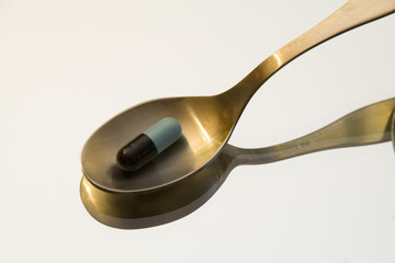 small spoon with capsule