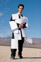 Businessman covered with papers