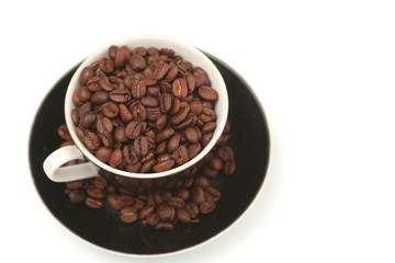 The black cup with fragrant coffee costs on a table