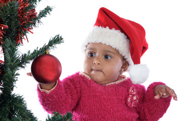 baby girl playing with christmas tree