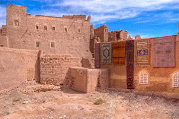casbah and carpets on the wall in morocco