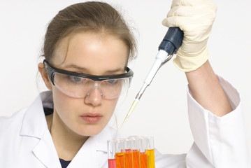 female scientist examining an orange solution