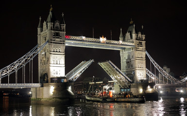 Night shot of Tower Bridge, paddle steamer passing by