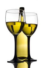 Bottle of white wine on a reflective tabletop. 