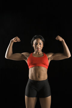 Woman athlete flexing muscles.