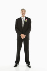 Groom in tuxedo.