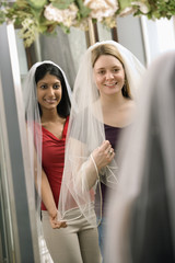 Friends trying on veils.