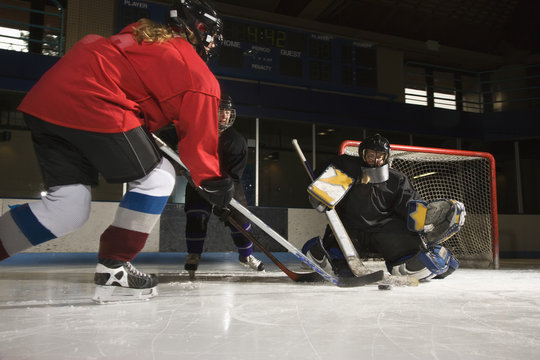 Women Playing Hockey.