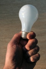 Hand holding light bulb