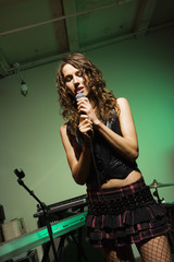 Fototapeta na wymiar Female singing into mic.