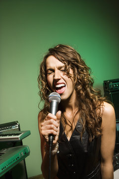 Female singing into mic.
