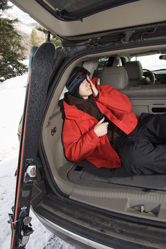 Teenager sleeping in car.