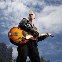 Naklejka premium Punk playing guitar.
