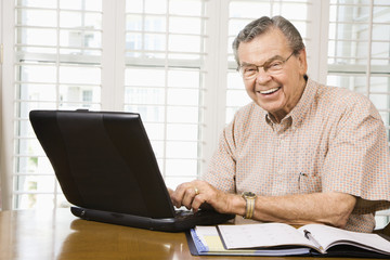 Mature man with laptop.