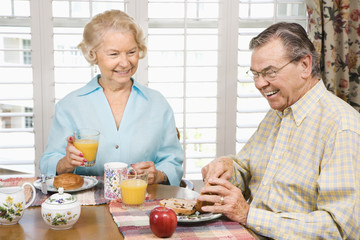 Mature couple eating breakfast.