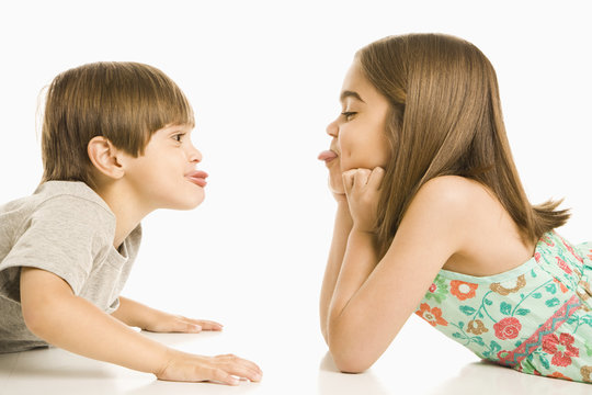 Children sticking out tongues.