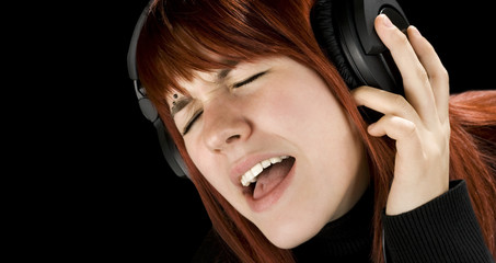 Cute redhead enjoying music