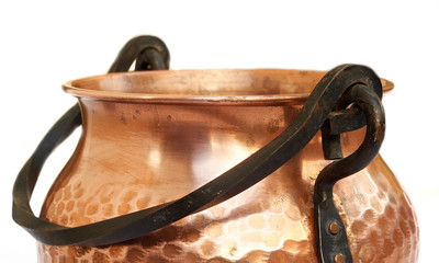 Macro close-up of brass pot isolated with white background