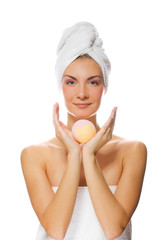 Beautiful young woman with aroma bath ball isolated on white bac