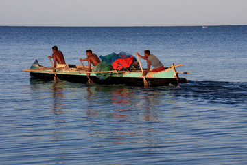 Malagasy fishermen and their outrigger canoes