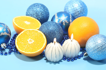 Orange juice, beads and candles. Christmas composition.