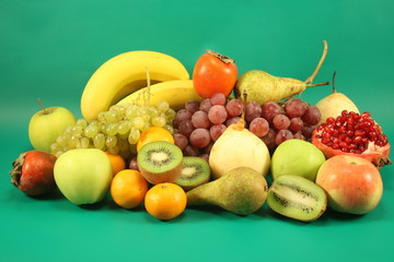 Different fruit on a green background.