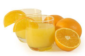 Glasses with orange juice and oranges