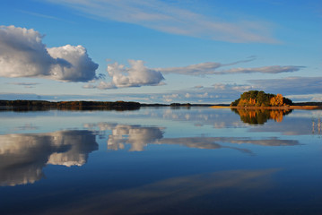 Reflection of sky and clouds on placid lake in Sweden