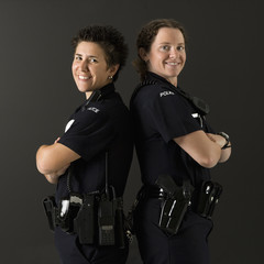 Policewomen back to back.