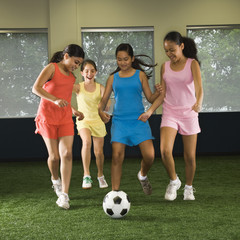 Girls playing soccer. © iofoto