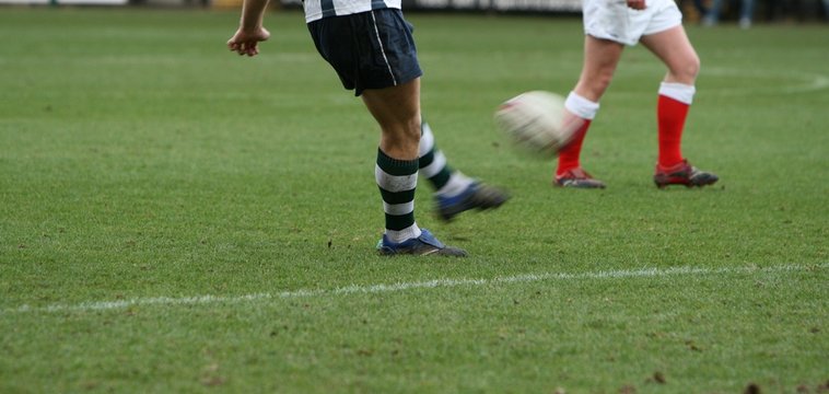 kicking rugby ball with motion blur
