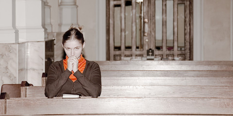 girl pray in a catholic church