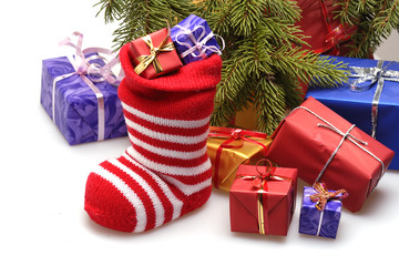 Christmas stocking and gifts under Christmas tree