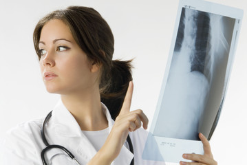 young and beautiful doctor looking at x-ray