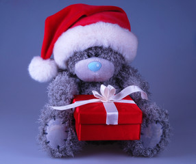 cute Santa bear in red hat with gift