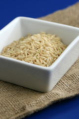 Healthy brown rice on a blue background