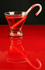 A christmas martini cocktail with a candy cane 