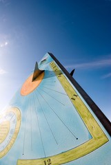 Pyramidal sundial on the background of shading blue sky