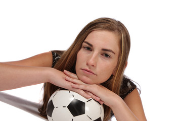 Model lying flat on soccerball with hands on top