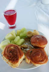 Rolls and fruit on a plate
