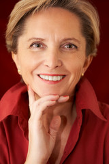 Mature woman looks straight at the camera.