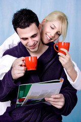 couple with morning coffee and newspapers